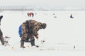 Fishermans on ice. Mans fishing on ice on gulf on Finland near Kronshtadt, Saint Petersburg, Russia, 03 February 2018