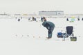 Fishermans on ice. Mans fishing on ice on gulf on Finland near Kronshtadt, Saint Petersburg, Russia, 03 February 2018