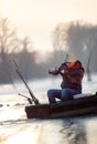 Fishing on ice- Fisherman sitting on frozen lake and drink tea Royalty Free Stock Photo