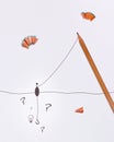 Fishing for ideas depicted using a pencil and sharpener waste with light bulb and question marks Royalty Free Stock Photo