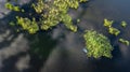 Fishing inflatable blue boat on forest lake. Aerial drone view