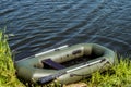 Fishing inflatable rubber boat standing on the shore of lake Royalty Free Stock Photo