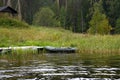 Fishing inflatable rubber boat stands on the shore of a lake with lush vegetation. The concept of outdoor recreation Royalty Free Stock Photo