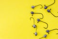 Fishing jig heads with hooks lie on a yellow background view from above with the clear area of half photo for labels, headers. Con Royalty Free Stock Photo