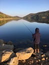 Fishing by the lake at dawn