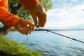 Fishing on the lake. Fisherman hanging a bell on a fishing rod, close-up, selective focus. Special equipment for fishing, bite