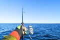 Fishing on the lake. Hands of fisherman with fishing rod. Macro shot. Fishing rod and hands of fisherman over lake water. Spinning Royalty Free Stock Photo