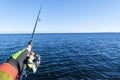 Fishing on the lake. Hands of fisherman with fishing rod. Macro shot. Fishing rod and hands of fisherman over lake water. Spinning Royalty Free Stock Photo