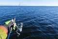 Fishing on the lake. Hands of fisherman with fishing rod. Macro shot. Fishing rod and hands of fisherman over lake water. Spinning Royalty Free Stock Photo