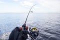 Fishing on the lake. Hands of fisherman with fishing rod. Macro shot. Fishing rod and hands of fisherman over lake water. Spinning Royalty Free Stock Photo