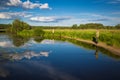 Fishing on the lake with lilies in rural location Royalty Free Stock Photo