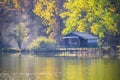 Fishing lake with piers and huts on a sunny autumn day Royalty Free Stock Photo