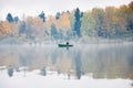 Fishing on the lake Senezh in Solnechnogorsk in the fall. The fog, the wind, the silhouette of a fisherman in a boat Royalty Free Stock Photo