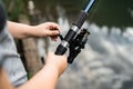 Fisherman with rod, spinning reel on the river bank. Sunrise. Fishing for pike, perch, carp. Fog against the backdrop of lake. Royalty Free Stock Photo