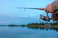 Fishing on the lake at sunset. Royalty Free Stock Photo