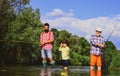 Fishing. Little boy fly fishing on a lake with his father and grandfather. Grandfather and father with cute child boy Royalty Free Stock Photo