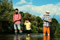 Fishing. Little boy fly fishing on a lake with his father and grandfather. Grandfather and father with cute child boy Royalty Free Stock Photo