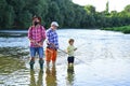 Fishing. Little boy fly fishing on a lake with his father and grandfather. Male multi generation family. Men day. Royalty Free Stock Photo