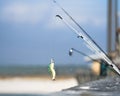 Fishing lure on pier with beach in background Royalty Free Stock Photo