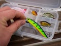 Fishing lures and accessories in the box background. Focus in the center of the bait Royalty Free Stock Photo