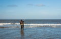 Fishing man casting the line at the seaside during the Sea fishing competition along the Northsea shore