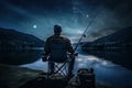 Fishing Man is Sitting at Night by Lake, Fishing Chair, Outdoor Tent, Fisherman Holds a Fishing Rod Royalty Free Stock Photo