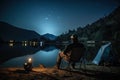 Fishing Man is Sitting at Night by Lake, Fishing Chair, Outdoor Tent, Fisherman Holds a Fishing Rod Royalty Free Stock Photo