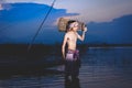 Fishing man use bamboo fish trap to catch fish in lake Royalty Free Stock Photo