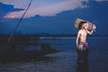 Fishing man use bamboo fish trap to catch fish in lake Royalty Free Stock Photo