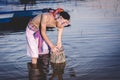 Fishing man use bamboo fish trap to catch fish in lake Royalty Free Stock Photo