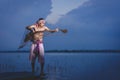 Fishing man use bamboo fish trap to catch fish in lake Royalty Free Stock Photo