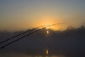 Fishing morning. Feeder rod on foggy sunrise background Royalty Free Stock Photo