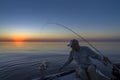 Fishing morning. Fisherman in boat catch fish Royalty Free Stock Photo