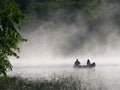 Fishing in the morning fog Royalty Free Stock Photo
