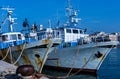 Fishing motorboats tied to mooring cleats