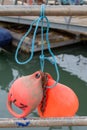 Fishing net floats tied to a railing at a dockside Royalty Free Stock Photo