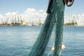 Fishing net hanging on board on fishing boat docked in the harbor Royalty Free Stock Photo