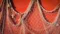 Fishing net hanging on red wall Royalty Free Stock Photo