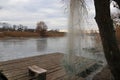 Fishing net hanging on a tree to dry. Tree near the lake, a place for fishing. Royalty Free Stock Photo