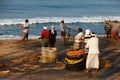 Fishing net with many fishermen on backside. Odayam beach, Varkala, India