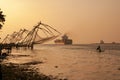 Chinese Fishing Nets in Cochi, Kerala, India, with Container Vessel in Background at sunset in colour Royalty Free Stock Photo