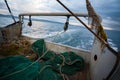 Fishing nets are on the deck of a small fishing vessel
