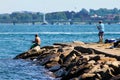 Fishing off the rocks at Fort Adams, Newport, RI. Royalty Free Stock Photo