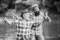 Fishing peaceful activity. Father and son fishing. Grandpa and mature man friends. Fisherman family. Rod tackle. Fishing Royalty Free Stock Photo