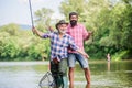Fishing peaceful activity. Father and son fishing. Grandpa and mature man friends. Fishing with spinning reel. Sunny Royalty Free Stock Photo