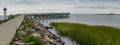 Fishing pier on Calf Pasture beach in summer day panorama with copy space