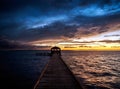 Fishing pier and dock silhouetted in a colorful sunset