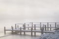 Fishing pier jetty in winter fog and mist Royalty Free Stock Photo