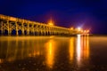 The fishing pier at night, in Folly Beach, South Carolina. Royalty Free Stock Photo