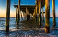 Fishing pier and waves on the Atlantic Ocean at sunrise in Ventnor City, New Jersey. Royalty Free Stock Photo